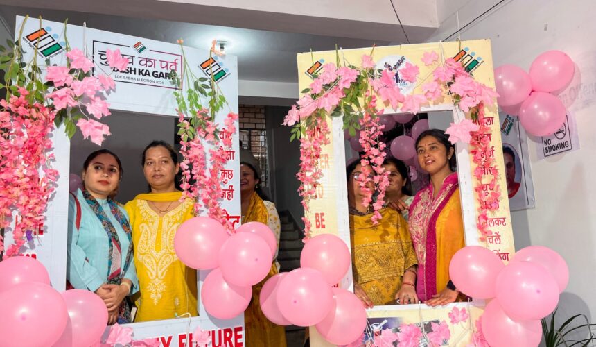 Polling officers pose for a photo at the pink polling station established by District Election Officer (DEO) Saloni Rai to attract female voters to cast their votes on the eve of the first phase of Lok Sabha Polls, in Udhampur on Thursday