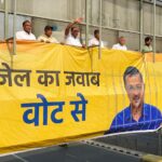 Aam Aadmi Party supporters install a poster in support of Delhi CM and party national convener Arvind Kejriwal, at ITO foot over bridge in New Delhi on Friday. Delhi CM was earlier arrested by ED in the alleged excise policy scam case.